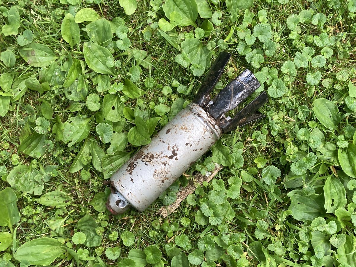 One is real and one is a replica. Photo of 9N235 submunition used to evaluate detection performance when partially covered with mud.